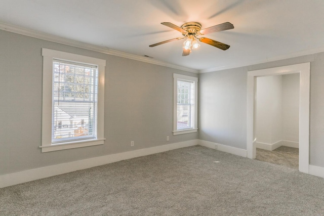 unfurnished room featuring ceiling fan, crown molding, and light colored carpet