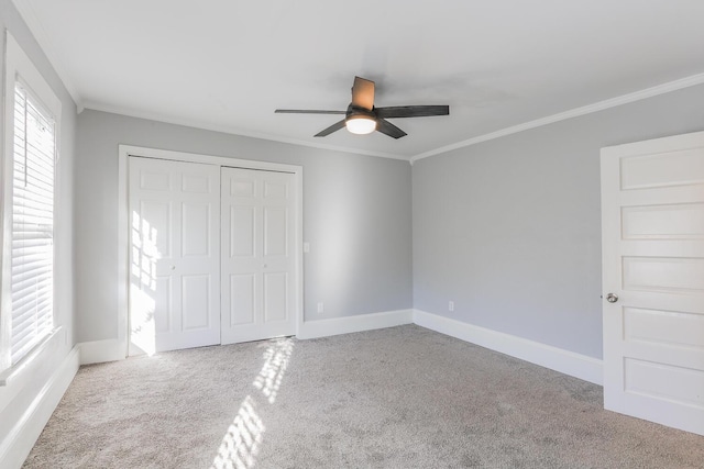 unfurnished bedroom with ceiling fan, crown molding, and light colored carpet