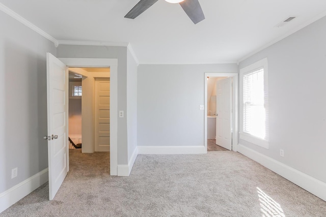 unfurnished bedroom featuring ceiling fan, light colored carpet, and ornamental molding