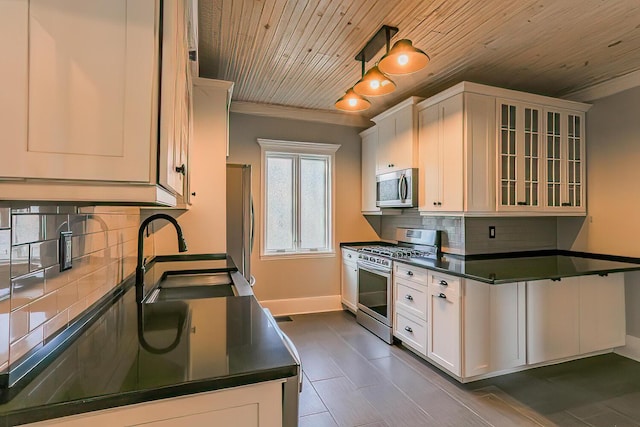 kitchen with white cabinets, sink, appliances with stainless steel finishes, and tasteful backsplash