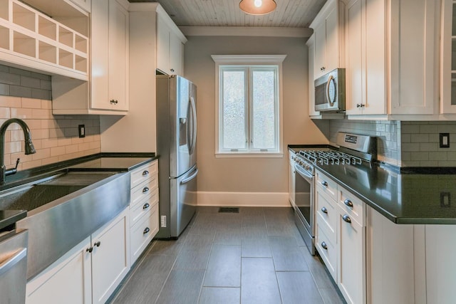 kitchen with white cabinets, decorative backsplash, wooden ceiling, and stainless steel appliances