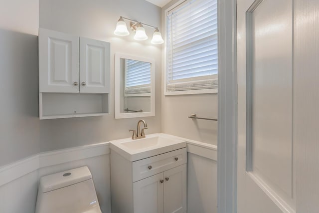 bathroom featuring vanity and toilet