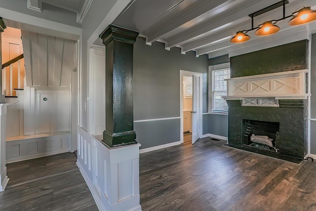 unfurnished living room with beamed ceiling, crown molding, and dark wood-type flooring