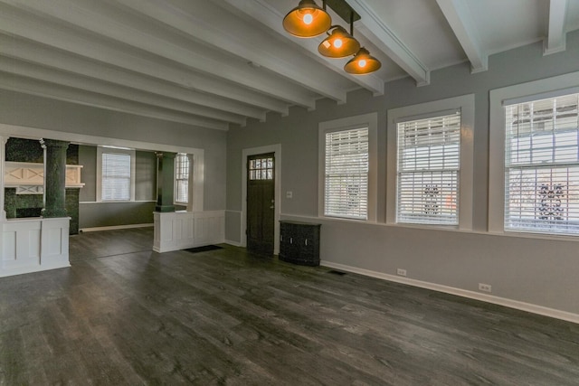 unfurnished living room with beam ceiling and dark hardwood / wood-style flooring