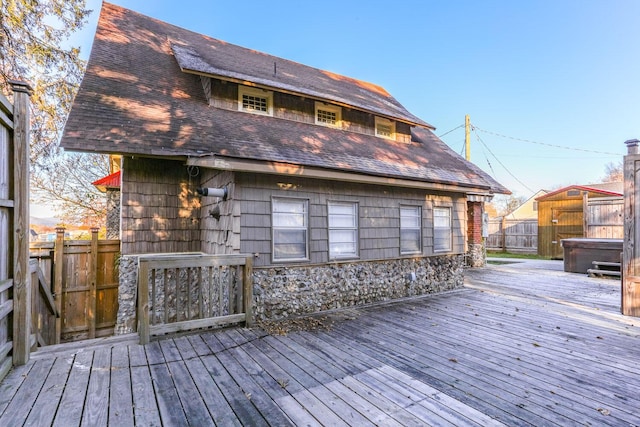 wooden deck featuring a hot tub