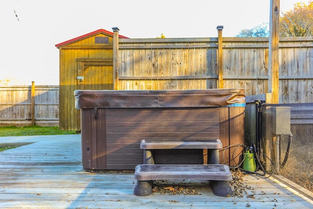 wooden deck with a hot tub