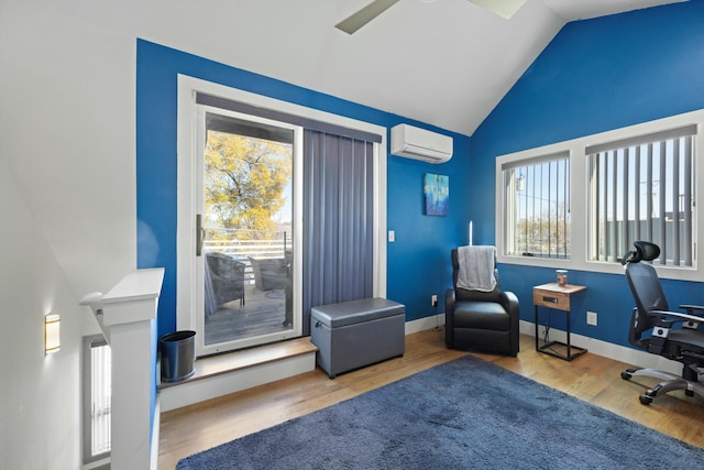 home office featuring hardwood / wood-style floors, lofted ceiling, ceiling fan, and an AC wall unit