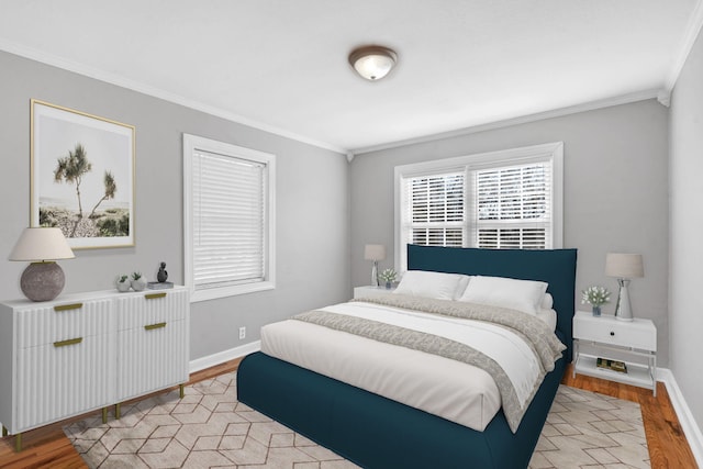 bedroom featuring ornamental molding and light wood-type flooring