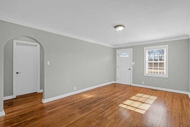 unfurnished room with hardwood / wood-style floors and crown molding