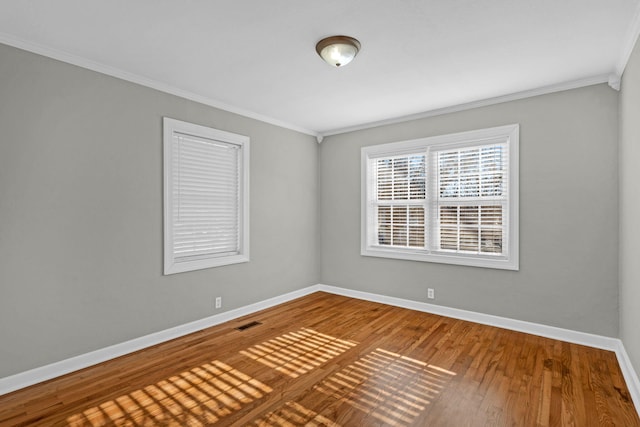 unfurnished room featuring ornamental molding and wood-type flooring