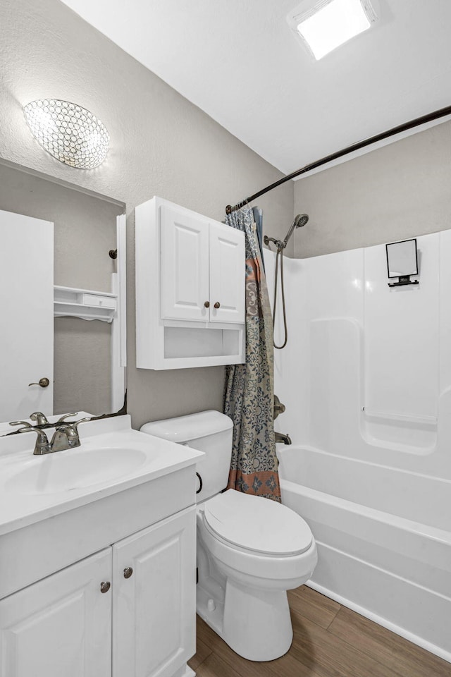 full bathroom featuring vanity, toilet, hardwood / wood-style floors, and shower / bath combo