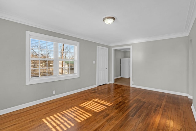 spare room with hardwood / wood-style floors and ornamental molding