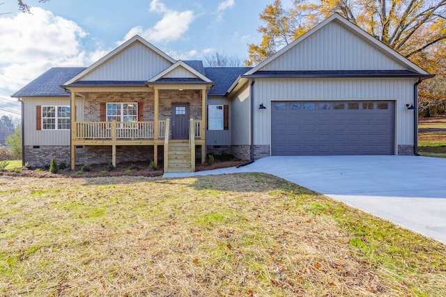 view of front of house with a porch, a garage, and a front lawn