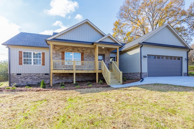 view of front facade with a garage, covered porch, and a front yard