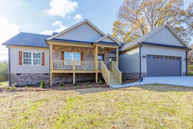 view of front of house with a garage, a front lawn, and covered porch