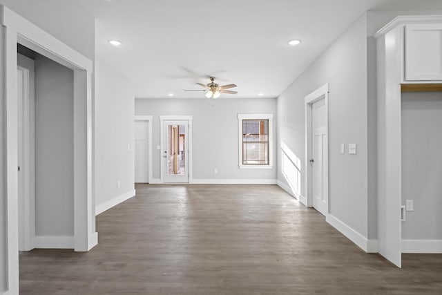 unfurnished living room with baseboards, dark wood finished floors, a ceiling fan, and recessed lighting