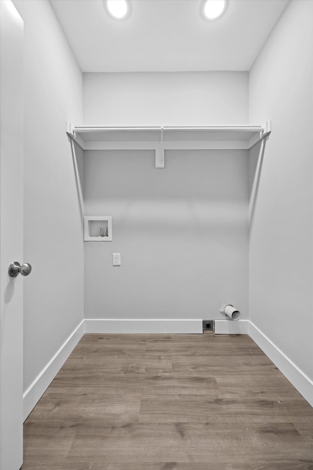 washroom with laundry area, baseboards, washer hookup, and wood finished floors