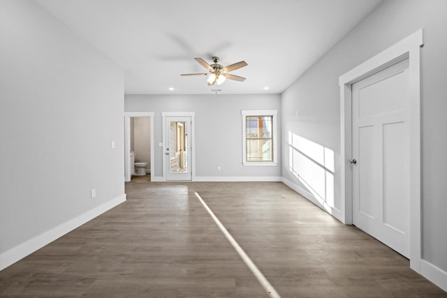 unfurnished bedroom with baseboards, dark wood finished floors, a ceiling fan, and recessed lighting