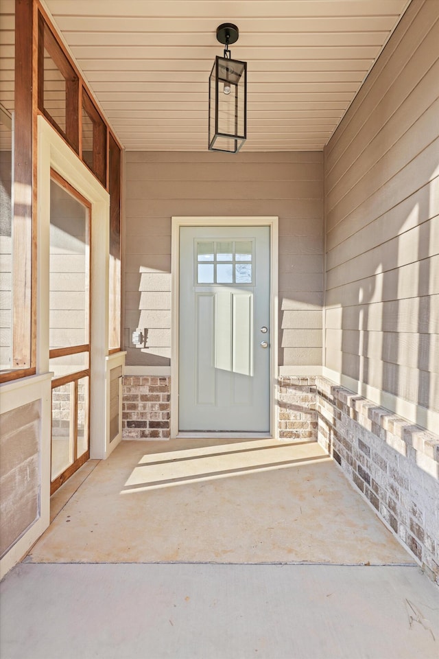 entrance to property with brick siding