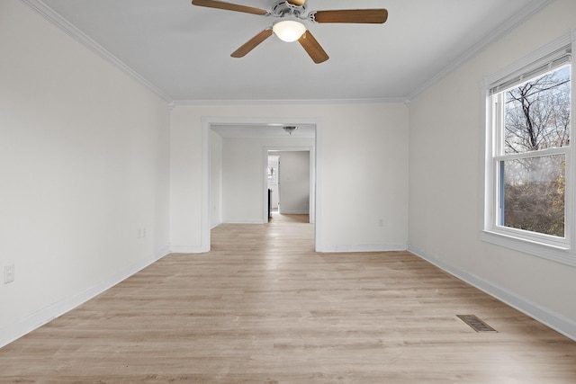 empty room featuring light hardwood / wood-style flooring, ceiling fan, and ornamental molding