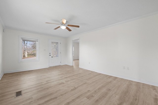 empty room featuring ceiling fan, light hardwood / wood-style floors, and ornamental molding