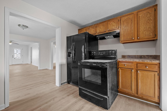 kitchen featuring a textured ceiling, light hardwood / wood-style flooring, ceiling fan, and black appliances