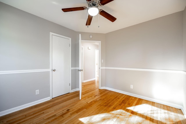 unfurnished bedroom featuring hardwood / wood-style floors and ceiling fan