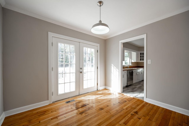 doorway to outside with sink, french doors, ornamental molding, and hardwood / wood-style flooring