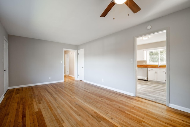 interior space with ceiling fan, light hardwood / wood-style flooring, and sink