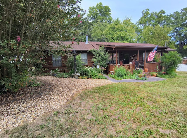 ranch-style home with a front yard and a porch