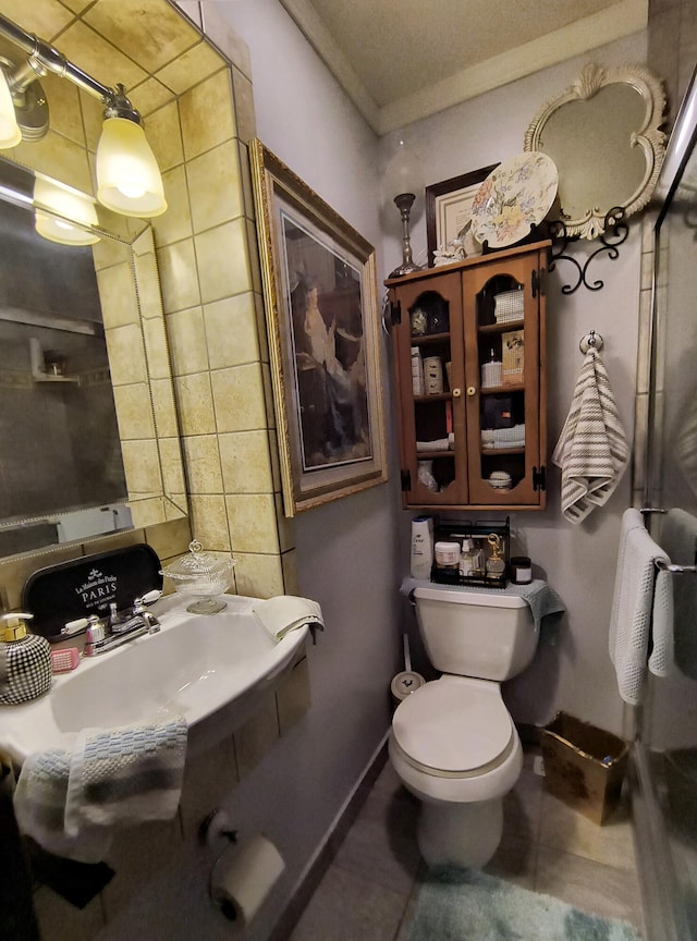 bathroom featuring tile patterned flooring, toilet, and sink