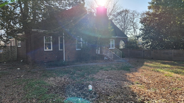 exterior space with brick siding and fence