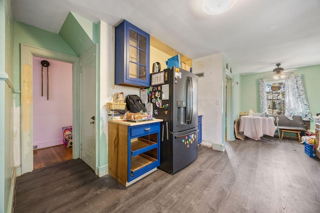 corridor with dark wood-type flooring and baseboards