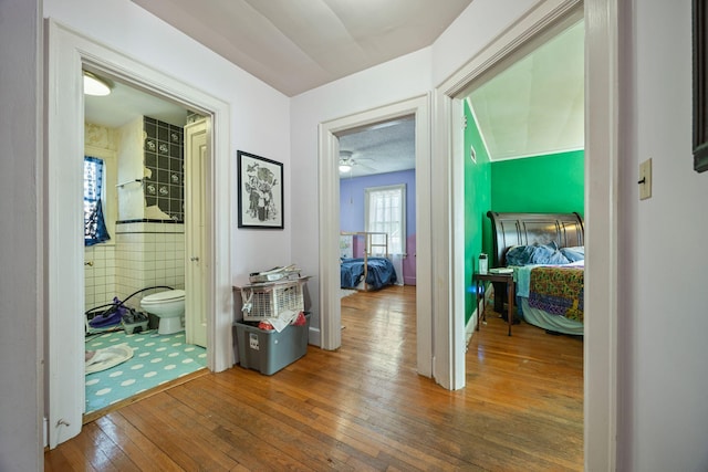 corridor with hardwood / wood-style floors