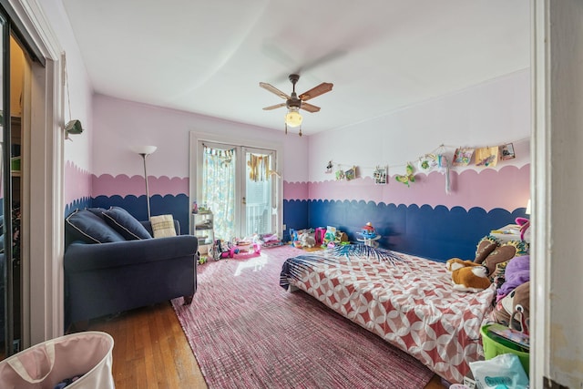 bedroom with a ceiling fan, access to outside, and wood finished floors