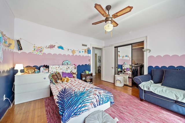 bedroom with a closet, visible vents, ceiling fan, and hardwood / wood-style flooring