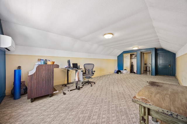 office area featuring a textured ceiling, lofted ceiling, carpet floors, and a wall mounted AC