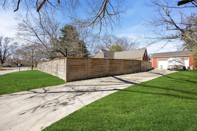 exterior space featuring a lawn and fence