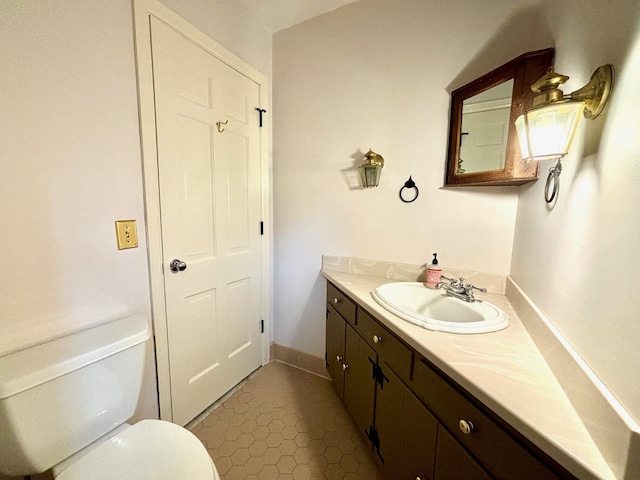 bathroom with tile patterned floors, vanity, and toilet