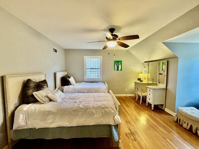 bedroom featuring wood-type flooring, vaulted ceiling, and ceiling fan