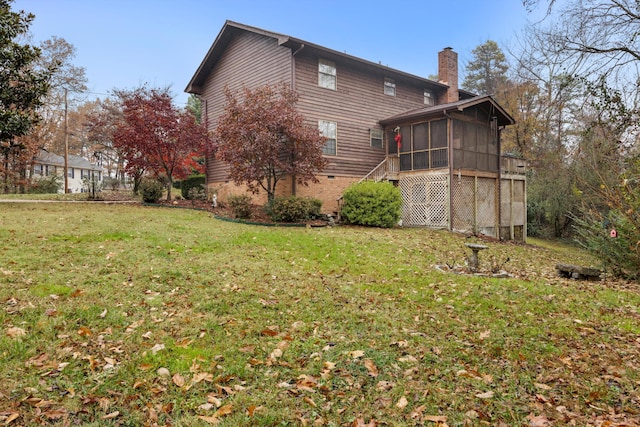 view of side of property featuring a yard and a sunroom