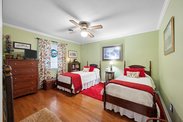 bedroom featuring wood-type flooring, a textured ceiling, ceiling fan, and crown molding