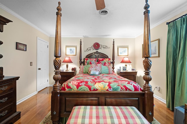 bedroom with ceiling fan, ornamental molding, and light hardwood / wood-style flooring