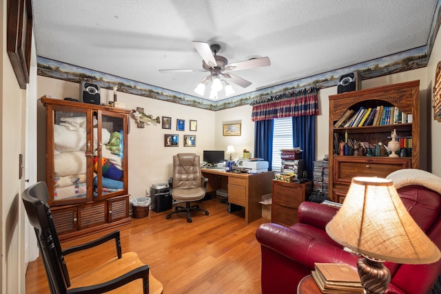 office featuring ceiling fan, wood-type flooring, and a textured ceiling