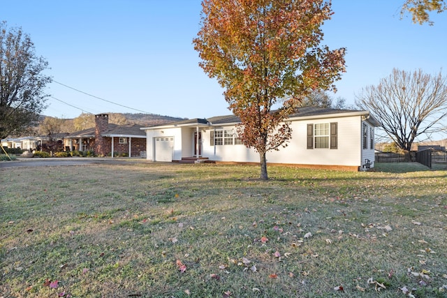 ranch-style home featuring a garage and a front yard