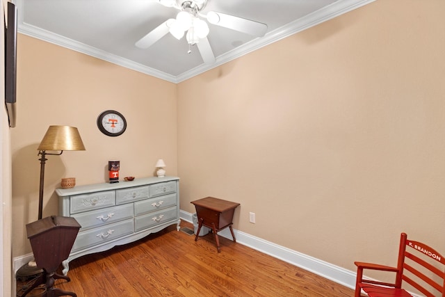 sitting room with ceiling fan, crown molding, and light hardwood / wood-style flooring