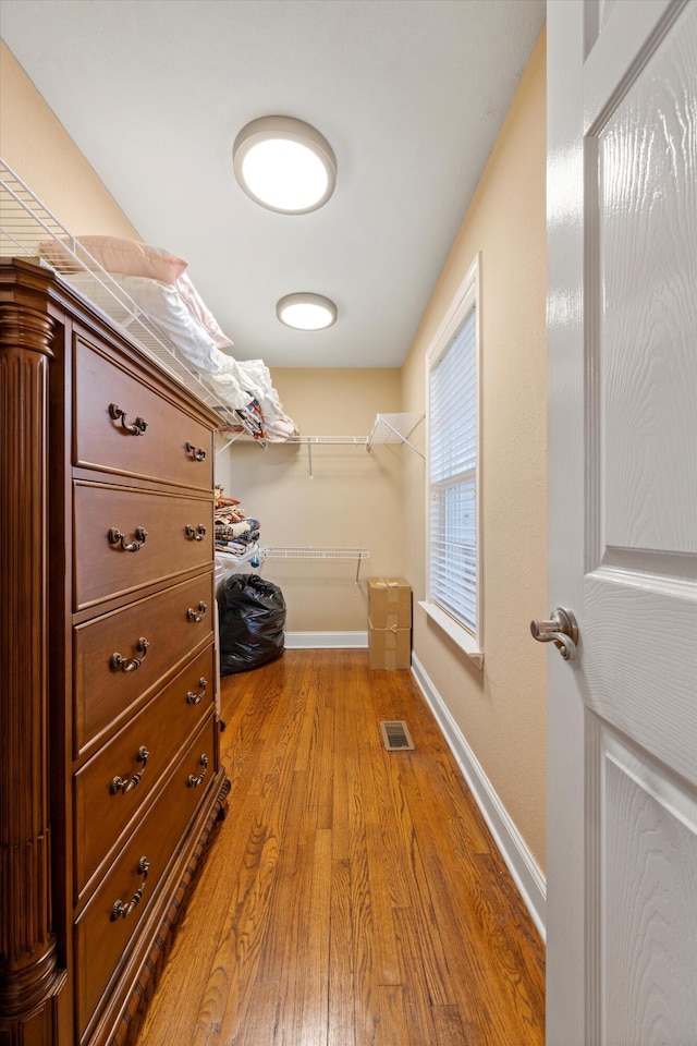 walk in closet featuring light hardwood / wood-style flooring