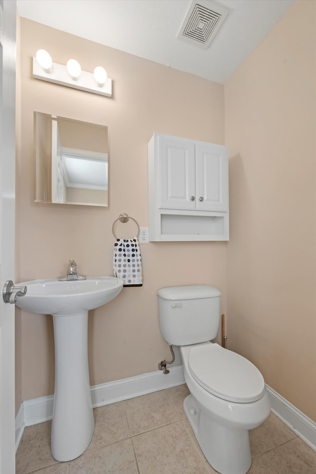 bathroom with tile patterned flooring and toilet