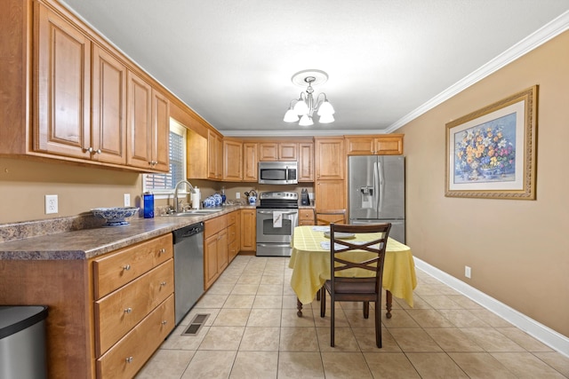 kitchen with ornamental molding, stainless steel appliances, sink, decorative light fixtures, and an inviting chandelier