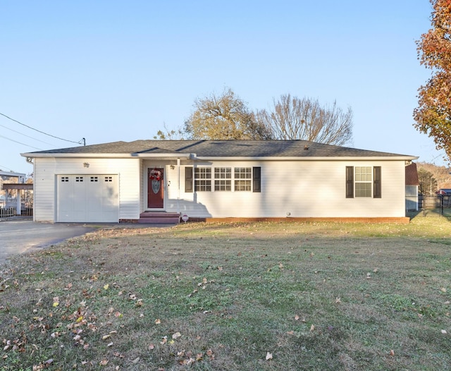 ranch-style home with a front yard and a garage